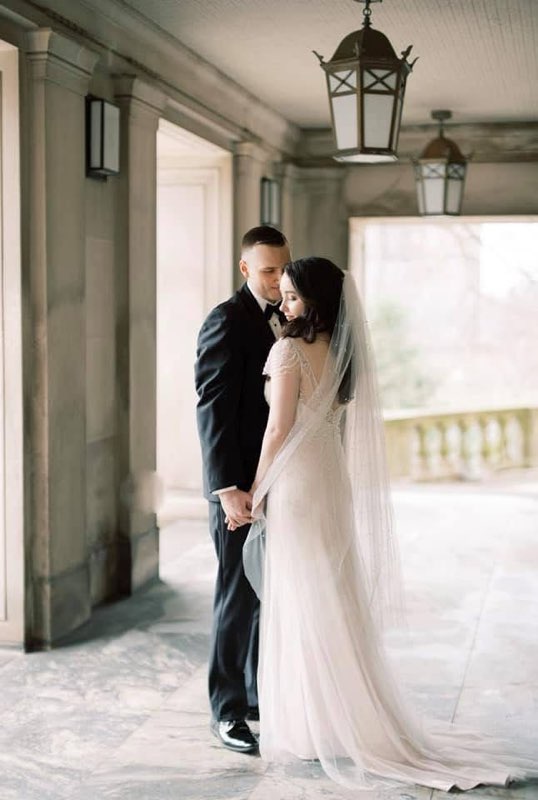 Bride And Groom Share An Intimate Moment In A Romantic Setting, Holding Hands Under Elegant Lanterns, Highlighting Their Love And Wedding Day.